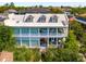 Elegant home featuring three floors of outdoor living space with white railings and vibrant greenery at 5 Legare St # C, Charleston, SC 29401