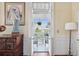 Balcony view from indoors through open french doors, with seating and hanging plants at 5 Legare St # C, Charleston, SC 29401