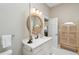 Charming bathroom featuring a decorative mirror, vanity, and a storage cabinet at 5 Legare St # C, Charleston, SC 29401