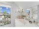 Bright bathroom featuring a marble countertop and a view of the neighborhood through a window at 5 Legare St # C, Charleston, SC 29401