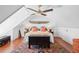 Bright bedroom with vaulted ceilings, wood floors, decorative trunk, and vintage decor at 5 Legare St # C, Charleston, SC 29401