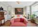 Bright and spacious bedroom features a large tiger painting and a cozy red sofa at 5 Legare St # C, Charleston, SC 29401
