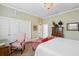 Bedroom boasts a large bed, a red sofa, and decorative antique storage at 5 Legare St # C, Charleston, SC 29401