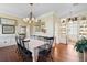 Dining room boasting an ornate chandelier, dark furniture, and classic details at 5 Legare St # C, Charleston, SC 29401