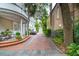 Brick driveway and walkways lead to this home with ample curb appeal and lush greenery at 5 Legare St # C, Charleston, SC 29401