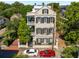 Charming three-story home featuring balconies, shutters, and well-manicured landscaping and a brick and wrought iron fence at 5 Legare St # C, Charleston, SC 29401