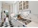 Stylish kitchen featuring white cabinetry, black and white floors, and modern appliances at 5 Legare St # C, Charleston, SC 29401