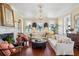 Open living room boasts hardwood floors, a fireplace, and white couches near several windows at 5 Legare St # C, Charleston, SC 29401