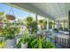Inviting front porch with comfortable seating, lush greenery, and neighborhood views at 5 Legare St # C, Charleston, SC 29401