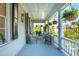 Charming porch with seating, ferns, and lovely neighborhood views at 5 Legare St # C, Charleston, SC 29401