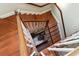 View looking down the wooden staircase with white risers and dark wood banister at 5 Legare St # C, Charleston, SC 29401