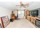 Bonus room featuring carpeted floors, built-in shelves, desk, ceiling fan and natural light at 5002 W Liberty Meadows Dr, Summerville, SC 29485