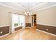 Dining room with stylish chandelier and views of the kitchen through a glass-paned door at 5002 W Liberty Meadows Dr, Summerville, SC 29485