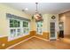 Sunny dining room with charming light fixture and view to back yard at 5002 W Liberty Meadows Dr, Summerville, SC 29485