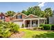 Charming two-story home with brick accents, front porch, attached garage, and manicured lawn at 5002 W Liberty Meadows Dr, Summerville, SC 29485