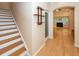 Hallway with hardwood floors, staircase, and view into the living room at 5002 W Liberty Meadows Dr, Summerville, SC 29485