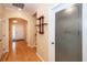 Hallway with hardwood floors leading to the front door and a frosted glass door for the laundry room at 5002 W Liberty Meadows Dr, Summerville, SC 29485