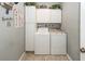Functional laundry room with washer, dryer, storage cabinets and neutral paint at 5002 W Liberty Meadows Dr, Summerville, SC 29485