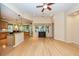 Open-concept living room with hardwood floors, ceiling fan, and lots of natural light at 5002 W Liberty Meadows Dr, Summerville, SC 29485