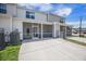 Townhome backyard has a covered porch and parking area with HVAC equipment at 502 Duskywing Dr, Goose Creek, SC 29445