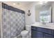 Bathroom features a decorative shower curtain and classic toilet and sink at 502 Duskywing Dr, Goose Creek, SC 29445