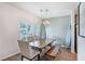 Charming dining room features a farmhouse table, stylish chairs, and a modern chandelier at 502 Duskywing Dr, Goose Creek, SC 29445
