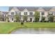 Exterior view of townhomes with pond frontage, showcasing the community's serene setting at 502 Duskywing Dr, Goose Creek, SC 29445