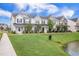 Beautiful townhome exteriors overlooking the community pond, enhancing the neighborhood's charm at 502 Duskywing Dr, Goose Creek, SC 29445