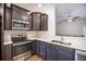 Kitchen features dark cabinetry, stainless steel appliances, and breakfast bar perfect for casual dining at 502 Duskywing Dr, Goose Creek, SC 29445