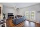 Cozy living room with plush seating, ceiling fan, and double doors with access to the outdoors at 502 Duskywing Dr, Goose Creek, SC 29445