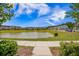 Community pond with walking path and lush greenery, offering a tranquil setting for residents at 502 Duskywing Dr, Goose Creek, SC 29445
