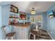 Entertaining bar with wood counter, galvanized metal, shelving, and casual seating at 5052 Hidden Forest Ln, North Charleston, SC 29420