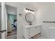 Bright bathroom with a modern vanity and an elegant round mirror over the sink at 5052 Hidden Forest Ln, North Charleston, SC 29420