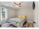 Cozy bedroom with a floral bedspread, ceiling fan, and a window with natural light at 5052 Hidden Forest Ln, North Charleston, SC 29420