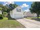 Well-maintained two story home with siding, garage, and front lawn at 5052 Hidden Forest Ln, North Charleston, SC 29420