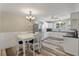 Eat-in kitchen featuring white cabinets, stainless appliances, and dining table at 5052 Hidden Forest Ln, North Charleston, SC 29420