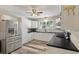 Modern kitchen featuring white cabinets, black countertops, and stainless steel appliances at 5052 Hidden Forest Ln, North Charleston, SC 29420