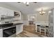 Open concept kitchen featuring an eat-in area, white cabinets, and stainless steel appliances at 5052 Hidden Forest Ln, North Charleston, SC 29420