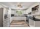 Bright kitchen with white cabinets, black countertops, and stainless steel appliances at 5052 Hidden Forest Ln, North Charleston, SC 29420