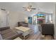 Spacious living room featuring wood flooring, ceiling fans, fireplace, and comfortable seating at 5052 Hidden Forest Ln, North Charleston, SC 29420