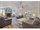 Spacious living room with a fireplace, ceiling fans, and modern flooring at 5052 Hidden Forest Ln, North Charleston, SC 29420