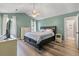 Relaxing main bedroom featuring a ceiling fan, wood-look flooring, and ample natural light at 5052 Hidden Forest Ln, North Charleston, SC 29420