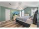 Bright main bedroom with a ceiling fan, wood-look flooring, and a comfortable bed at 5052 Hidden Forest Ln, North Charleston, SC 29420