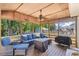 Covered porch with comfortable seating, a ceiling fan, and a grill at 5052 Hidden Forest Ln, North Charleston, SC 29420