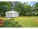 Detached two-car garage stands in the well-manicured lawn of the backyard at 521 Carpenter St, Charleston, SC 29412