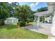Detached two-car garage stands in the well-manicured lawn of the backyard at 521 Carpenter St, Charleston, SC 29412