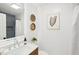 Bathroom featuring a vanity with decorative items, framed artwork, and a white shower curtain at 521 Carpenter St, Charleston, SC 29412