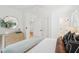 Bright bedroom features a ceiling fan, neutral decor, decorative wall art, and en suite bathroom at 521 Carpenter St, Charleston, SC 29412
