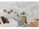 Bright bedroom features a ceiling fan, neutral decor, decorative wall art, and an adjacent doorway at 521 Carpenter St, Charleston, SC 29412