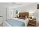 Bright bedroom featuring a woven headboard, neutral decor, natural light, and wood flooring at 521 Carpenter St, Charleston, SC 29412